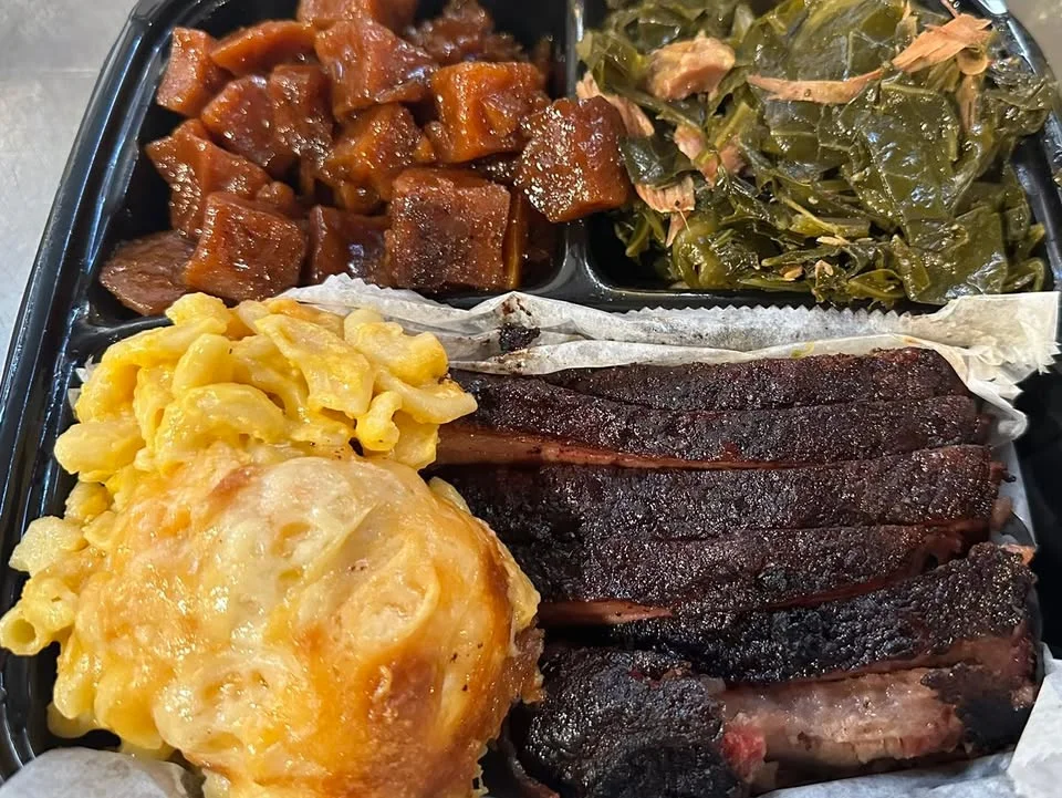 Southern BBQ platter with brisket, mac and cheese, and greens